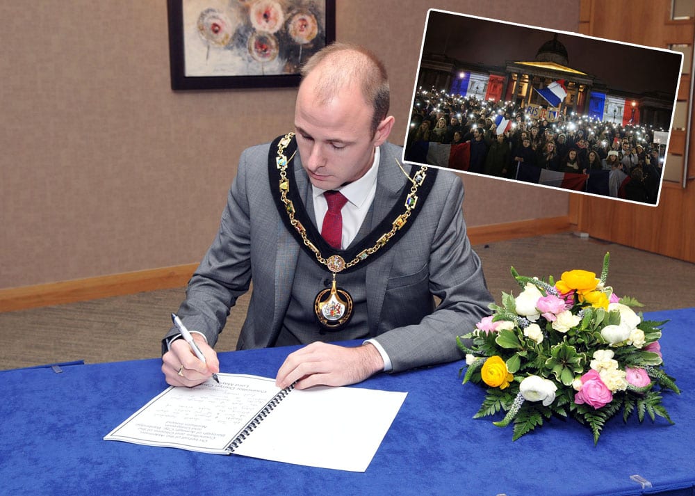Lord Mayor of Armagh City, Banbridge and Craigavon Borough Council, Councillor Darryn Causby opens the book of condolence at Craigavon Civic Centre.