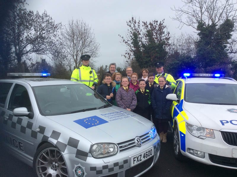 Cllr Roisin Mulgrew with MP Mickey Brady, Principal Kearns, pupils from St Malachy's and officers from the PSNI road safety team