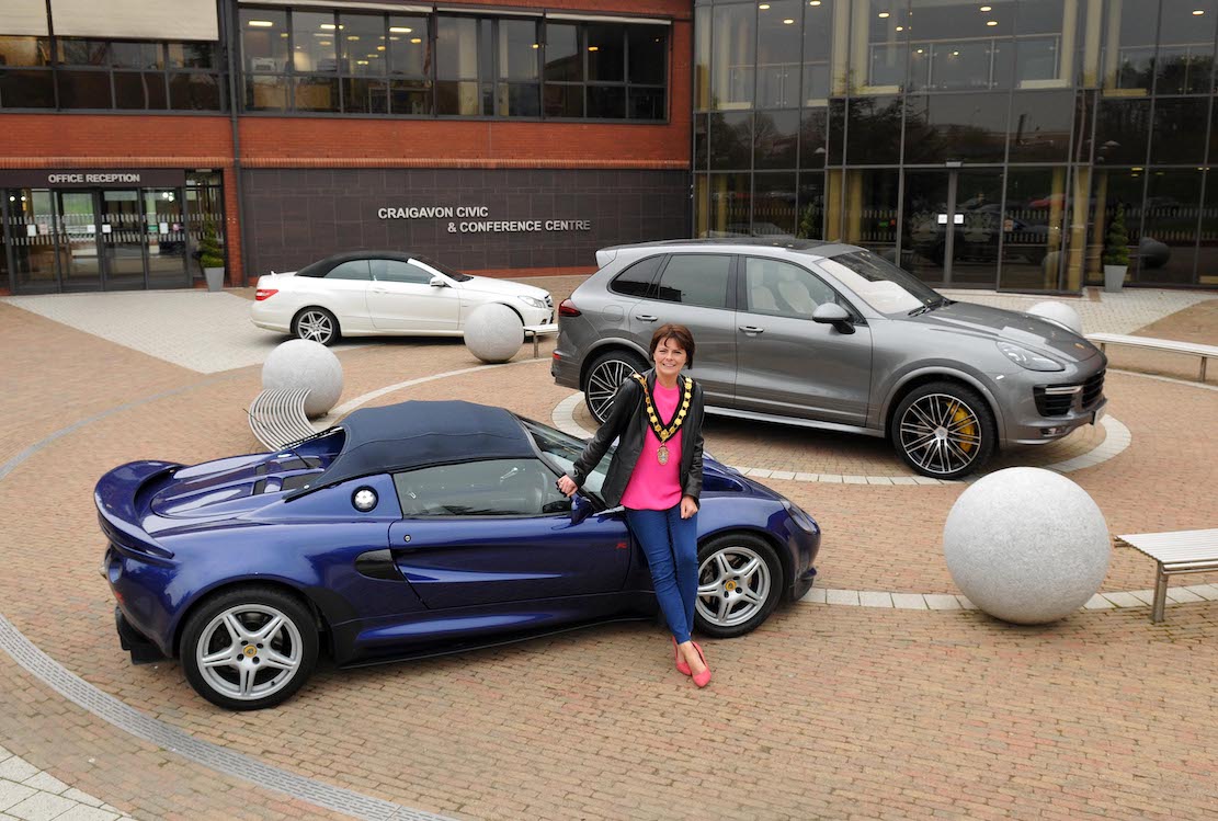 Lord Mayor of Armagh City, Banbridge and Craigavon, Councillor Julie Flaherty with a few of the cars which will be on display at the Cars, Bikes and Coffee Evening at Craigavon Civic Centre on 9th May.