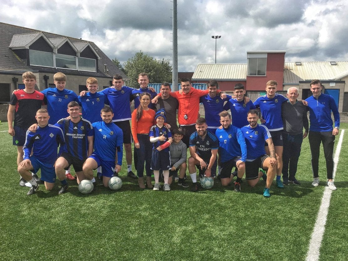 Liam Burns presented with kit bag and goodies by Armagh City FC players