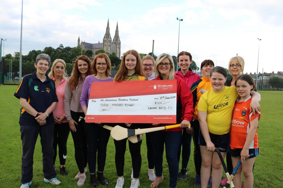 St Brigid's Camogie Club present cheque to Air Ambulance NI