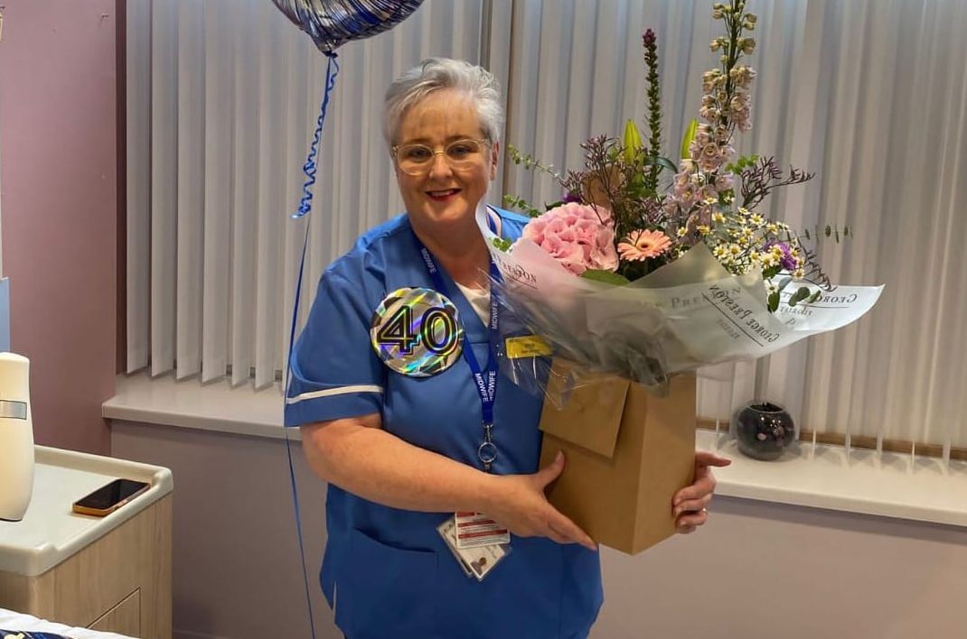 Phil Fletcher, a midwife in Daisy Hill Hospital, has celebrated 40 years’ service in the Southern Health and Social Care Trust. She is pictured at a celebration event held in Daisy Hill on 3 August alongside her colleagues.